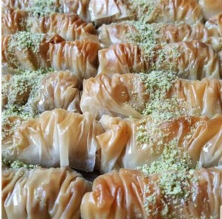 Baklava finger by Ashikat Kitchen Cylindrical baklava fingers with finely ground pistachio decoration by Ashikat Kitchen