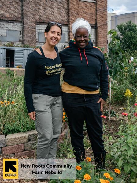 Sheryll and Maria, from IRC in NY, standing in front of the New Roots Community Farm