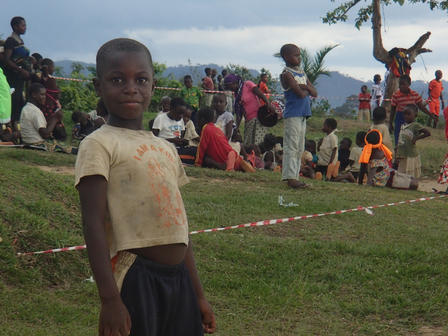 Smiling boy Orphaned Freddy is happy to be on a soccer team