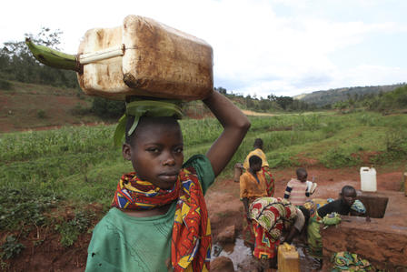 Children fetch water from a well in the Muyenga province of Burundi