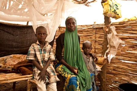 A family in their thatch home in Yola. 