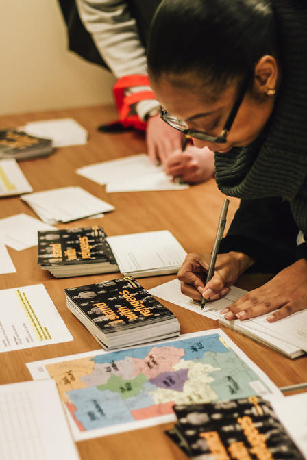 Attendees wrote postcards to Georgia representatives, explaining why they welcome refugees Attendees wrote postcards to Georgia representatives, explaining why they welcome refugees