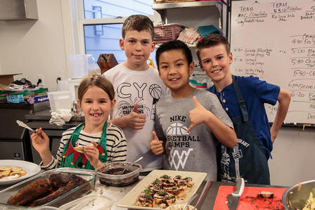 Kid chefs preparing a meal in support of refugees in the Bay Area.