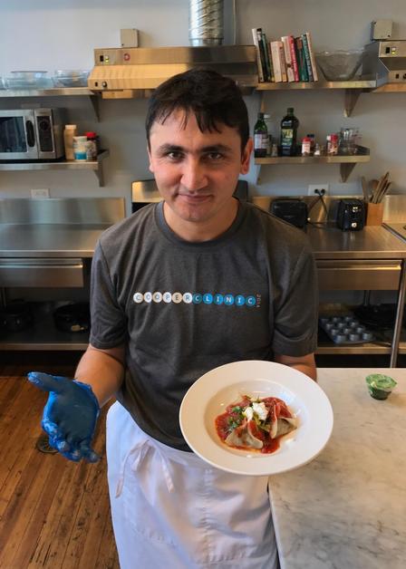 Hamid shows off a dish he created.