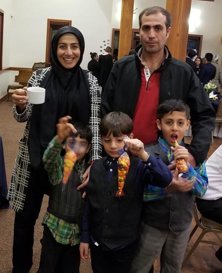 Moustafa envisioned a life in the U.S. with his family and his brother's family. The travel ban prevented this dream. Moustafa family poses at Breaking Bread dinner.