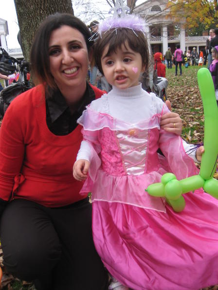 Farah and her daughter go trick-or-treating on the Lawn at UVA.