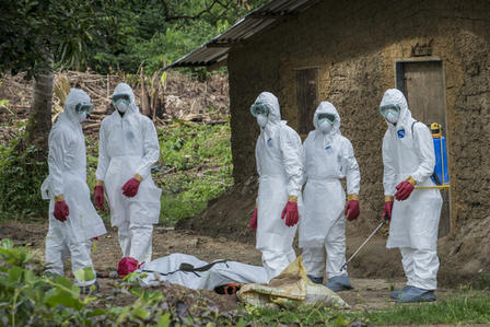 A burial team in Liberia about to carry away the body of a man suspected of having died from the Ebola outbreak in 2014. A burial team in Liberia about to carry away the body of a man suspected of having died from the Ebola outbreak in 2014.