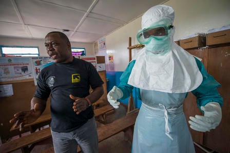 During the 2014 Ebola outbreak in West Africa, the IRC trained local health workers in how to use personal protective equipment when treating Ebola patients. 