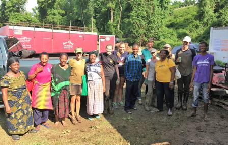 Farmers, volunteers, and New Roots staff members cleaning up at the farm following the flood.
