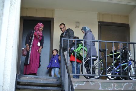 A Syrian family on the landing of their new apartment in Dallas