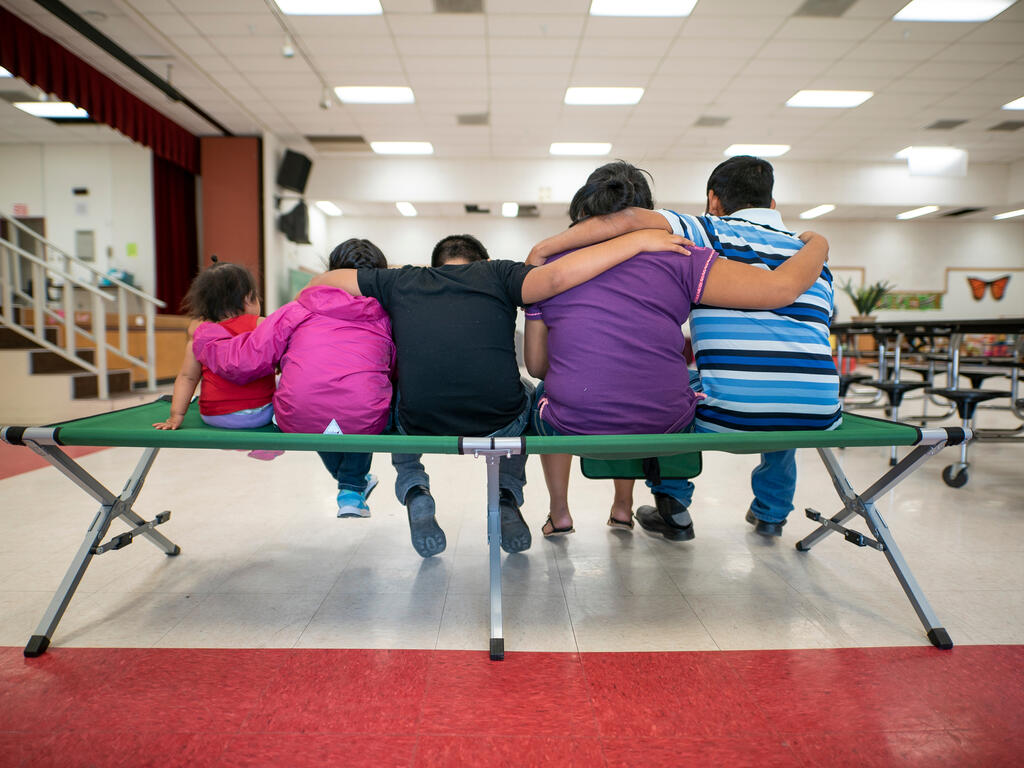 Marta, Julio and their children sit with their backs to the camera.