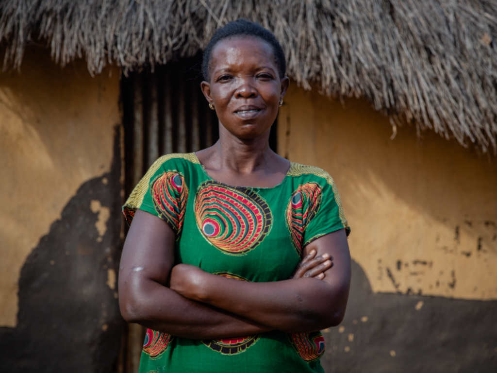 A woman standing in of her home.