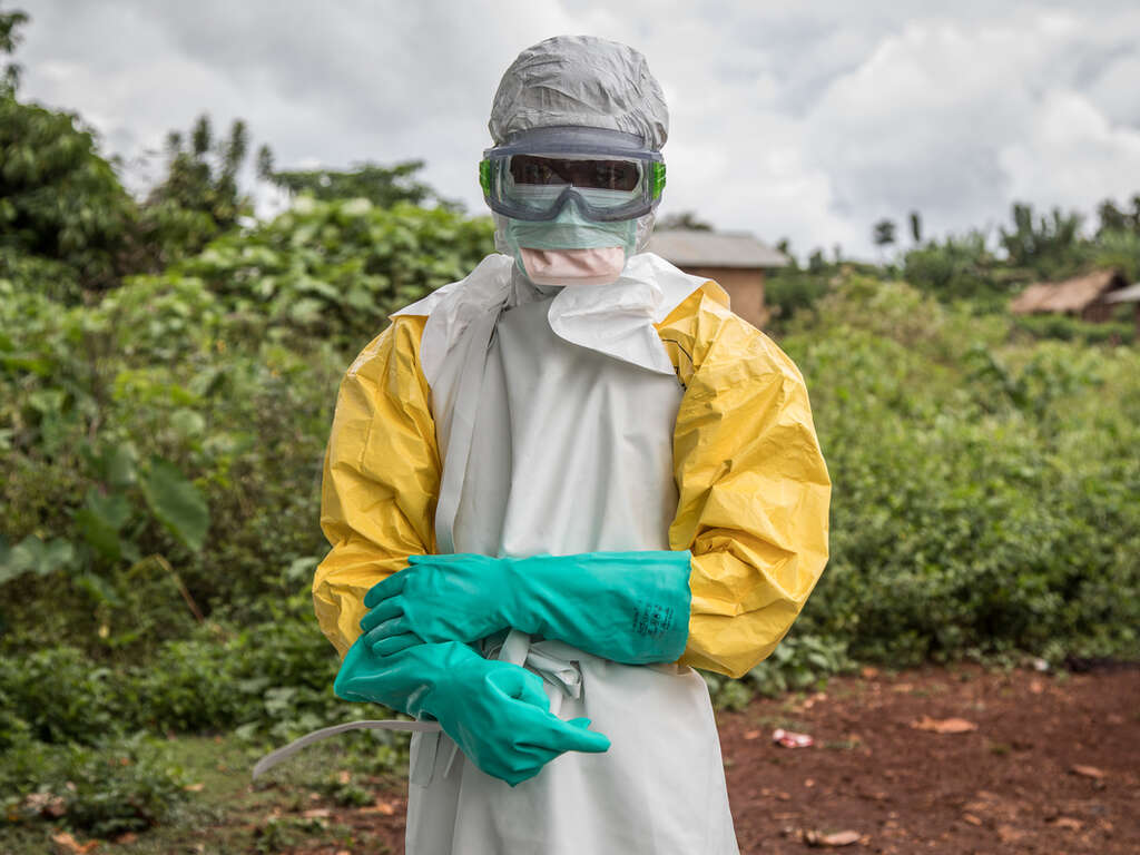 Sjukvårdspersonal som är klädd i fullständig personlig skyddsutrustning för att desinficera Case Du Salut-vårdinrättningen i Mabalako, Kongo-Kinshasa