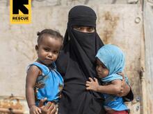 A vully veiled mother with her two children