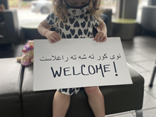 Three-year-old Juniper welcomes Afghans arriving to the United States. 