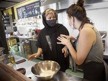 Two women talking and making the Bolani recipe.