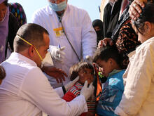 Doctor helping children