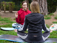 Khrystyna teaching a private yoga class in a city center park.