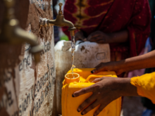 Person filling a water container in Somalia.