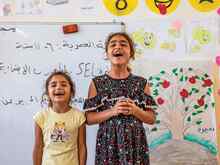 Two young Yazidi girls living in Sinjar, Iraq, participate in summer activities at a public school supported by the International Rescue Committee.