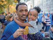 Tolassa Elemaa hugs his daughter Fenete after completing the New York City Marathon. Tolassa is originally from Ethiopia and was resettled by the International Rescue Committee in Dallas, Texas.
