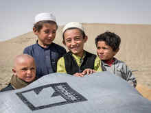 Smiling children welcome the distribution of the winterized kits in Killa Abullah, Balochistan, Pakistan.
