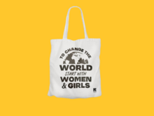 Tote bag with text "to save the world start with women and girls"