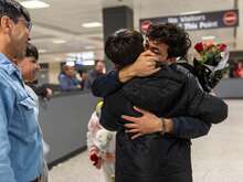 Wasiqullah hugs his little brother for the first time in years as he reunites with his family at the Dulles Airport in Virginia.