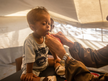 A young boy receives treatment for malnutrition