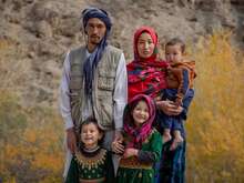 An Afghan family poses for a photo outside, near their home in rural Afghanistan.