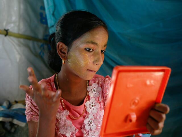 Nur Kiyas applying traditional make-up to her face