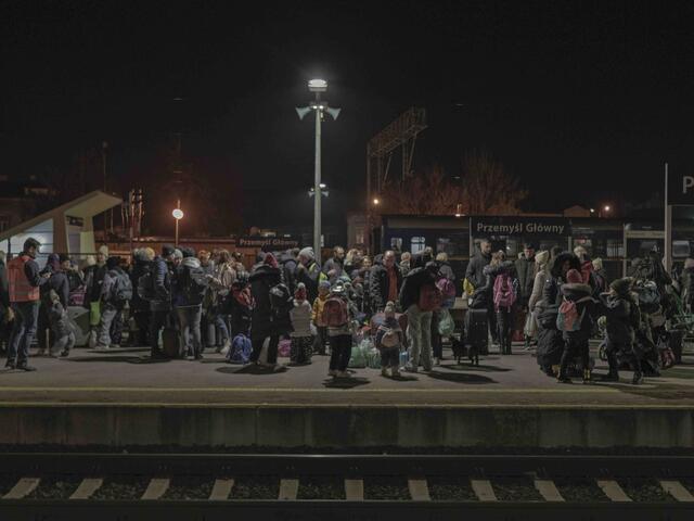 Ukrainian refugees wait at Polish railway station