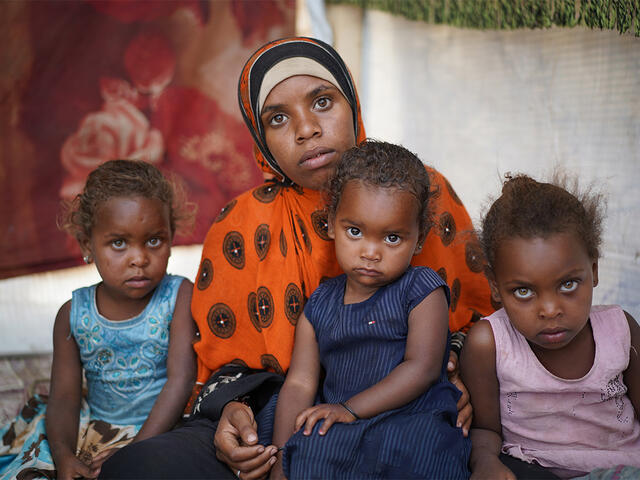 Bodor Ali Muhammad, 21, sits with her three daughters in Modhoor camp in Yemen.