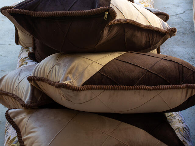Picture of stacked pillows on the floor.