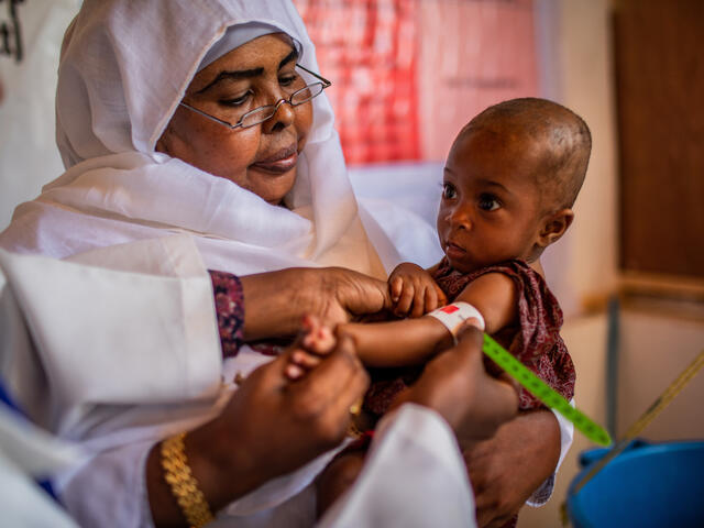 Somali mother holding a small malnourished baby