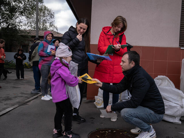 People line up to receive winter items.