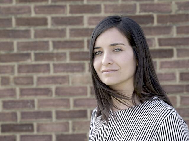 A woman standing in front of a wall