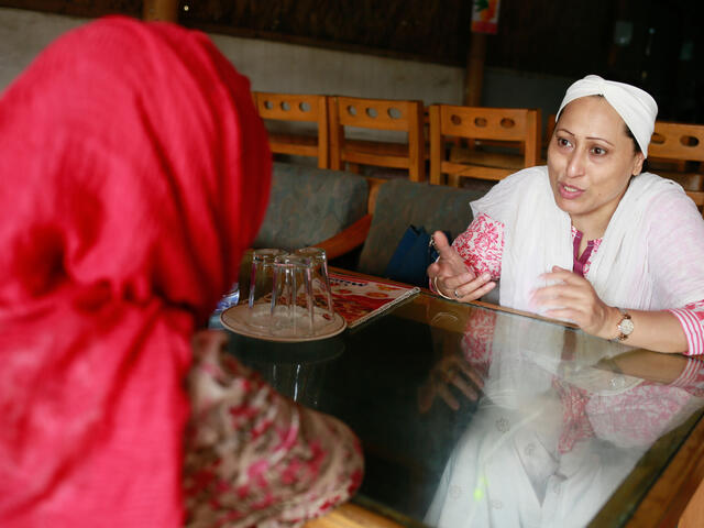 Razia speaking to a woman