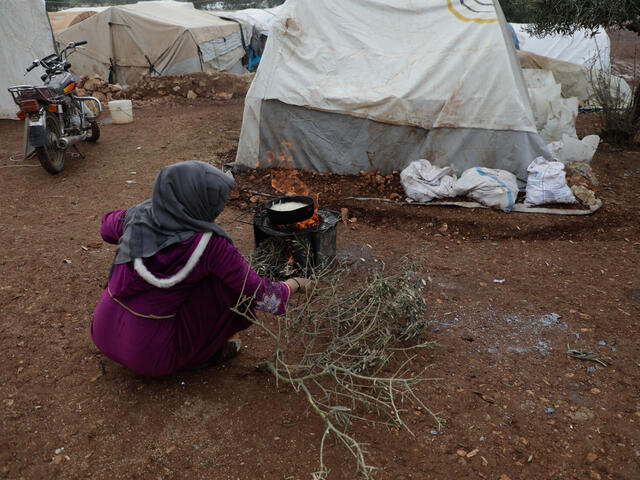 A woman on the ground next to some tents