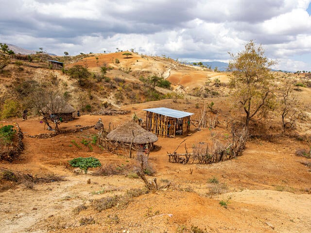A small hut in a displaced persons camp in Konso, Ethiopia is surrounded by a drought-stricken landscape.