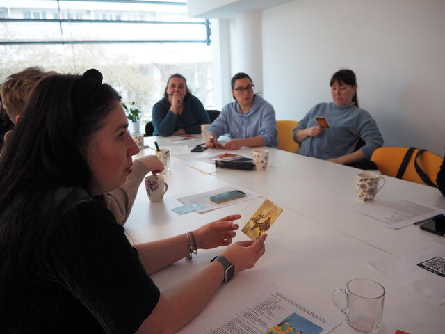 Yana and others sit around a table