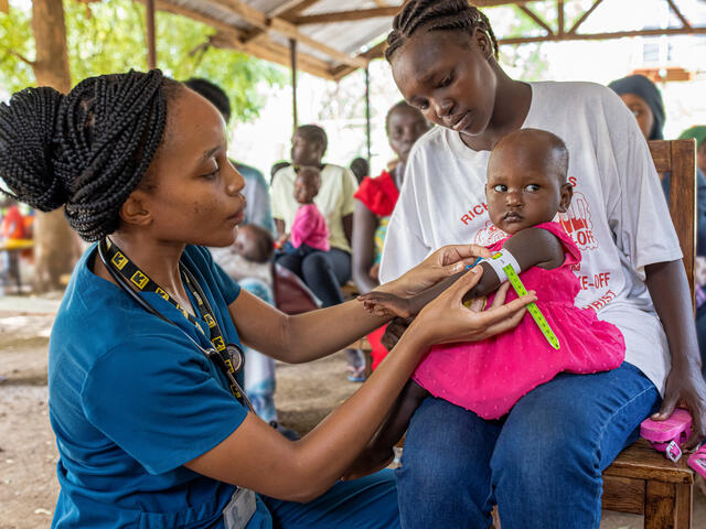 Dr. Sila checks one-year-old Vanessa for malnutrition at Locher Angamor Health Dispensary.