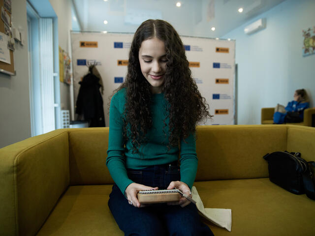 Lera, participant in Teenage Camp, sitting on a sofa