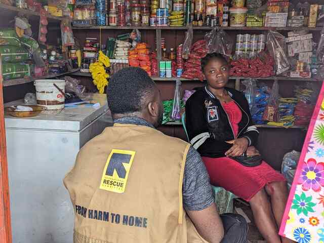 An IRC staff member meets Mercy at her provisions store in Buea, Cameroon. Together, they reflect on the progress of the business.