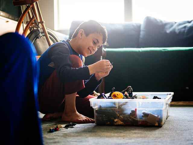 Child opening gift form light one candle sponsors.