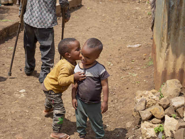 Ein kleiner Junge gibt seinem Freund ein Küsschen.