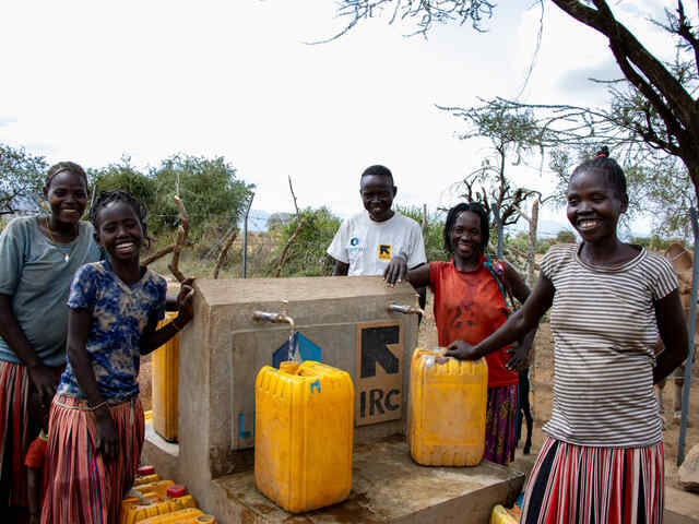People fetch water from the IRC build water point.