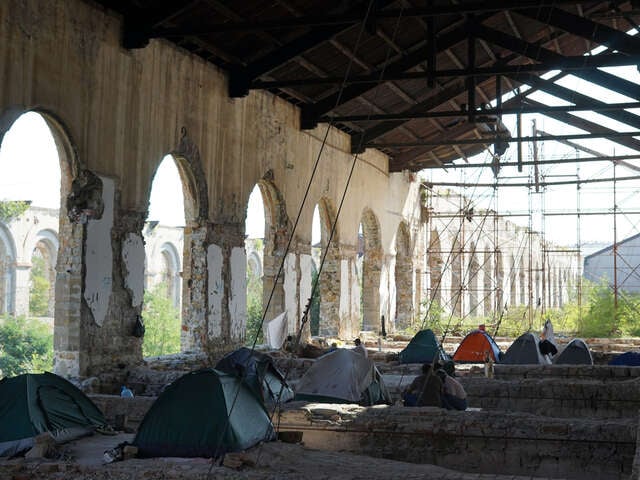 Tält i en övergiven byggnad i Italien, asylsökande bor där då de mottagningscenter som finns är överfulla.