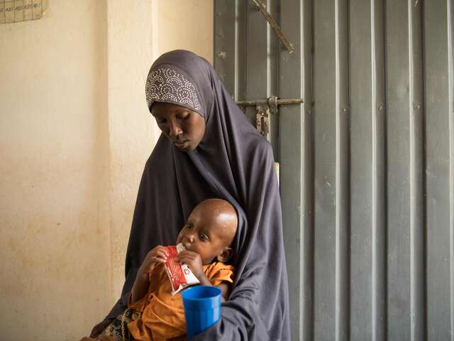 Two-year-old Mowlid eats a high protein peanut paste, also known as ready-to-use therapeutic food (RUTF), as treatment for his severe acute malnutrition. As part of our simplified approach, the IRC recommends providing RUTF as the primary treatment product for all children diagnosed with acute malnutrition.