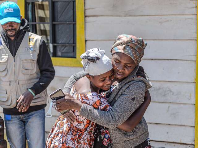Gentille and Fatuma share a hug after receiving a kit for Gentille.